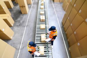 workers in a goods warehouse - storage and transport of goods by mail order