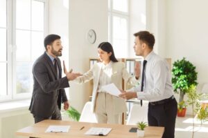 Business team of angry people shouting and arguing during a meeting in an office